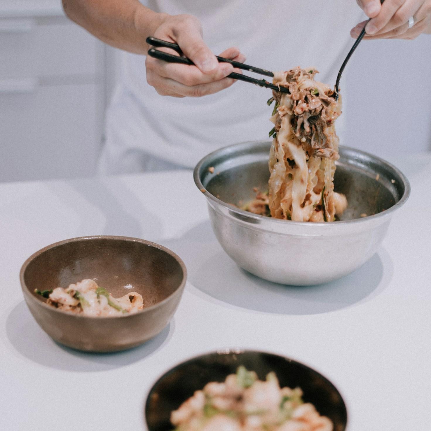 Community members working together in a modern kitchen, sharing recipes and techniques